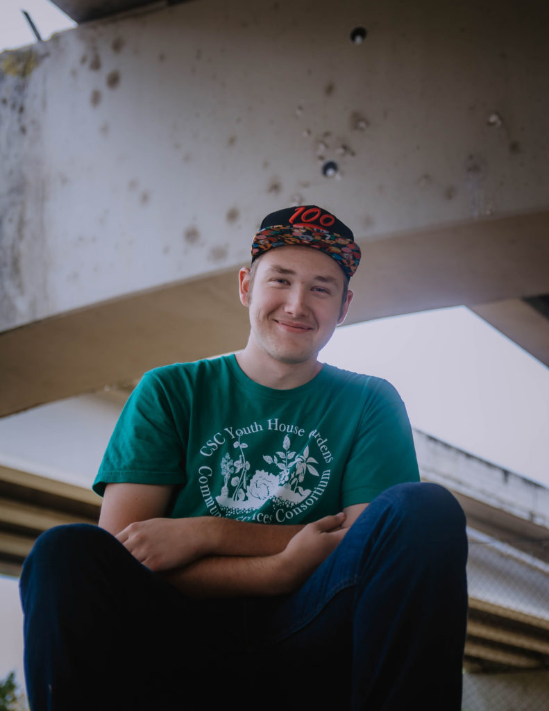 Youth smiling with arms crossed
